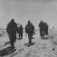 Группа солдат немецкой армии в зимнем обмундировании идет по дороге Фото