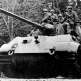 Немецкие парашютисты едут на броне танка Тигр II во время наступления в Арденнах Фото