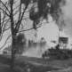 Немецкий тягач Sd.Kfz. 10 с пушкой PaK 35/36 следует по улице горящей советской деревни Фото